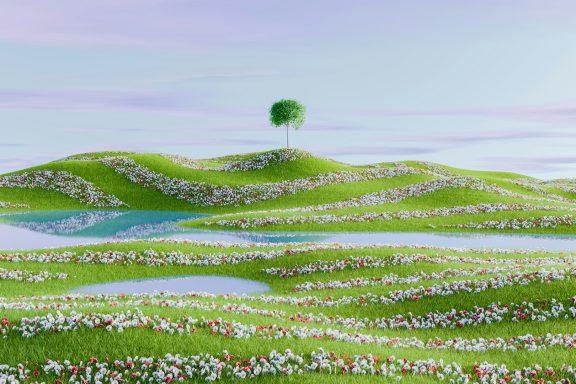 Land Lush green hills covered with flowers and a single tree under a pastel sky.